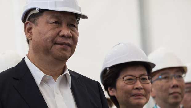In the early days, Xi Jinping and Carrie Lam visit a section of the Hong Kong-Zhuhai-Macau bridge in Hong Kong in 2017. 
