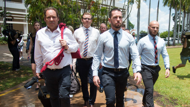 Constable Zachary Rolfe (centre) leaves the Northern Territory Supreme Court. 