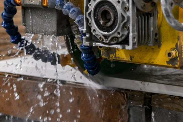 Engineered stone being cut at a factory.