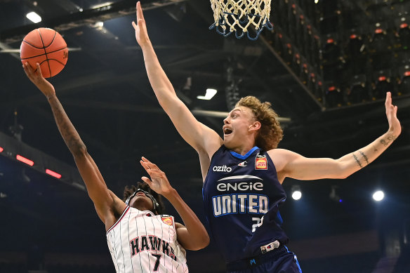 Luke Travers attempts to block the shot of Illawarra’s AJ Johnson.