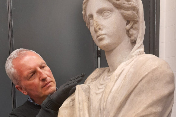 The British Museum’s Dr Peter Higgs, prepares statue of a woman in Parian marble, dated about 150-100 BCE, for transportation to Australia in 2021.