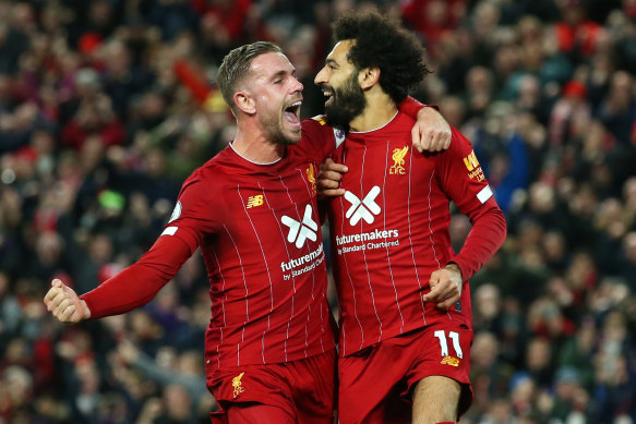 Liverpool's Jordan Henderson, left, and Mohamed Salah, right, celebrate a goal. 