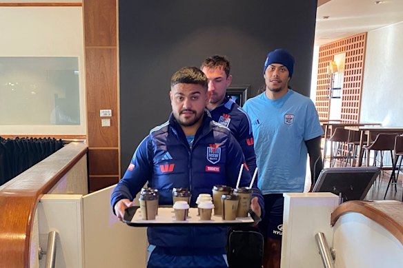 Latrell Mitchell delivers the coffee order in Blues camp this week.