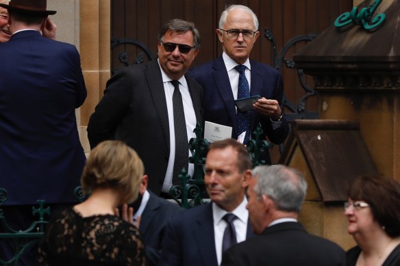 Former prime ministers Tony Abbott (below, centre) and Malcolm Turnbull  (above, right) after the funeral.