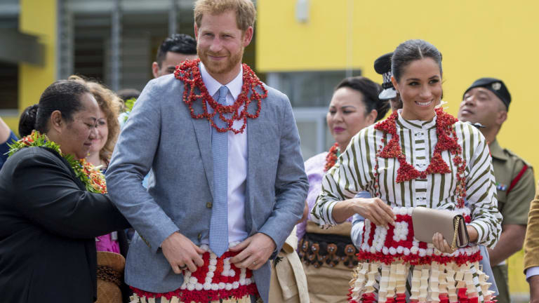 Britain's Prince Harry and Meghan, Duchess of Sussex wear a ta'ovala, a traditional Tongan dress wrapped around the waist, at the Fa'onelua Convention Centre in Nuku'alofa, Tonga.
