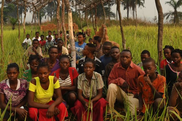 Students sit where their desks once were, amongst the ruins of their school after it was burnt down during the fighting in the Kasai conflict. At least 639 schools were burnt down.