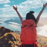 Young asian women hikers climbing up on the peak of mountain near ocean. Woman hiking in the mountains standing on a rocky summit ridge with backpack. Roys peak track, South island, New Zealand. roy's peak nz