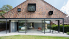 A sunburst brick collage references the front porch in this rear extension to a 1937 house in Roseville,  Sydney.