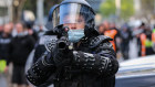 A member of the Critical Incident Response Team is seen with a non-lethal capsicum canister firearm during a protest at the CFMEU headquarters on Monday.