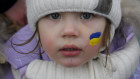 A Ukrainian three-year-old flees from the conflict into neighbouring Romania. 