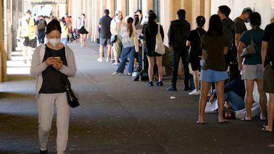 People wait outside the Central Station COVID-19 testing clinic. 