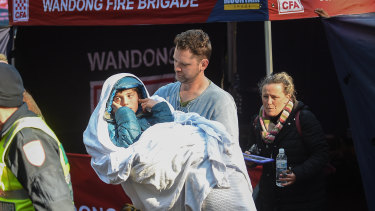 Will Callaghan, in his stepfather's arms, after being found. His mother Penny follows close behind.