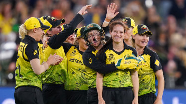 Schutt to thrill: The Australian women's team celebrate after Megan Schutt (second from right) dismissed India's Shikha Pandey in the T20 World Cup final at the MCG.