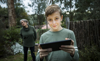 Elizabeth Schreiber watching her son Ben playing Fortnite on iPad. 