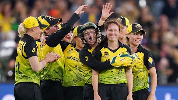 Schutt to thrill: The Australian women's team celebrate after Megan Schutt (second from right) dismissed India's Shikha Pandey in the T20 World Cup final at the MCG.