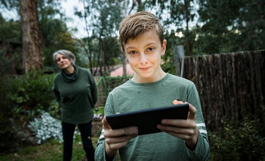 Elizabeth Schreiber watching her son Ben playing Fortnite on iPad. 