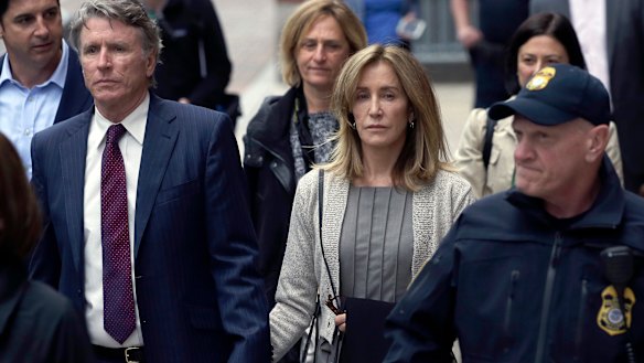 Guilty of college admissions bribery: Felicity Huffman, centre, in federal court.