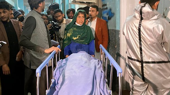Afghans carry the body of a woman, one of three media workers killed by gunmen in Jalalabad, east of Kabul, Afghanistan.