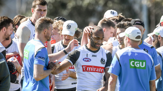 Collingwood players and coaching staff get around Travis Varcoe after he spoke to them at Thursday's training session.