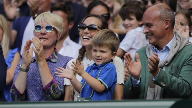 Jelena Djokovic, wife of Novak Djokovic of Serbia and their son applaud after the match.