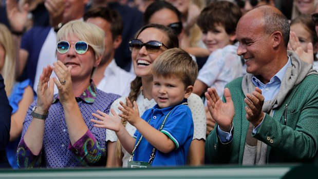 Jelena Djokovic, wife of Novak Djokovic of Serbia and their son applaud after the match.