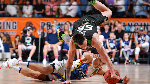 Rough and tumble: Mitch Creek puts it all on the line against Anthony Drmic of the 36ers.