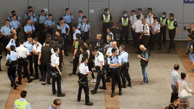 Police and members of airport security stand at the Hong Kong International Airport in Hong Kong, China.