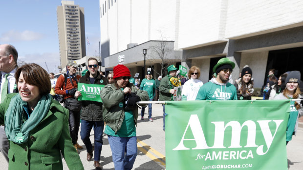 2020 Democratic presidential candidate Sen. Amy Klobuchar waves as she walks in the St. Patrick's Day Parade.