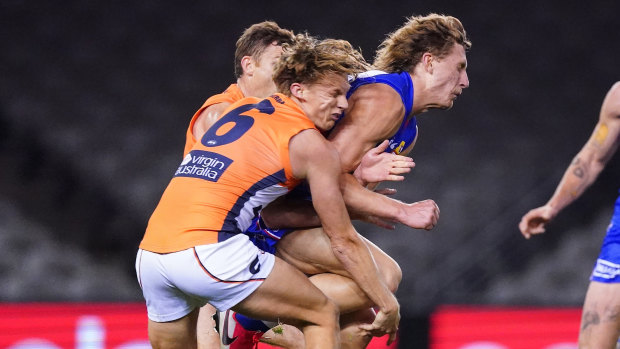 Aaron Naughton collects Lachie Whitfield. The GWS star suffered a concussion from the blow.