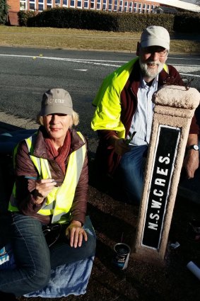 The concrete pillar signposts restored in Barton in 2016-17 with the help of the Kingston and Barton Residents Group.Pictured are Nick and Liz Swain .
