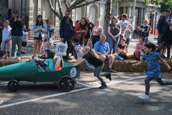 Children take part in a billycart race in North Melbourne in October. 