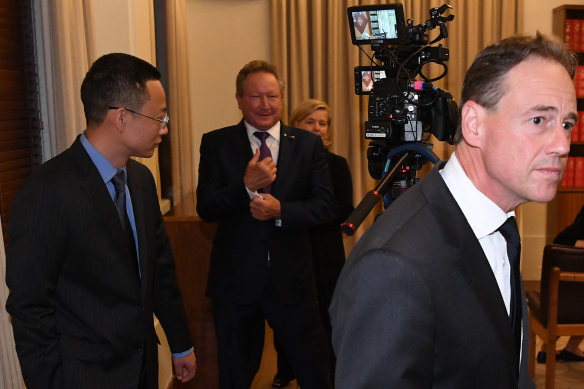 Hijacked: Health Minister Greg Hunt walks away from Chinese consul-general Zhou Long and Andrew Forrest after Wednesday's press conference.
