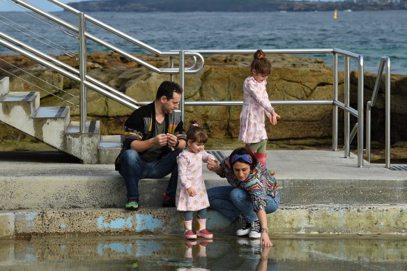 Tony and Gena Been with their daughters Winona, 5, and Daisy, 2, at the children’s pool at Bondi Beach.
