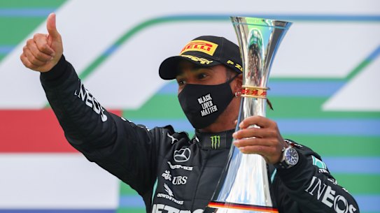 Mercedes driver Lewis Hamilton celebrates on the podium after winning the Eifel Formula One Grand Prix at the Nuerburgring racetrack in Nuerburg, Germany on Sunday.