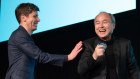 OpenAI Chief Sam Altman and SoftBank Chief Masayoshi Son joke around on stage at their event in Tokyo.