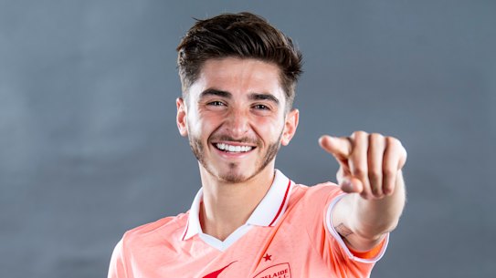 ADELAIDE, AUSTRALIA - NOVEMBER 15: Josh Cavallo poses in their coral strip during the Adelaide United A-League headshots session at Adelaide Entertainment Centre on November 15, 2021 in Adelaide, Australia. (Photo by Mark Brake/Getty Images for APL)