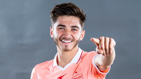 ADELAIDE, AUSTRALIA - NOVEMBER 15: Josh Cavallo poses in their coral strip during the Adelaide United A-League headshots session at Adelaide Entertainment Centre on November 15, 2021 in Adelaide, Australia. (Photo by Mark Brake/Getty Images for APL)