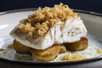 Butter-poached cod fillet topped with beer-batter bits.