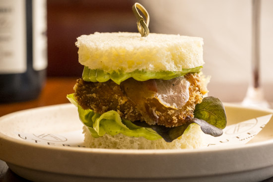 Auterra’s guanciale-draped abalone schnitzel sandwich.