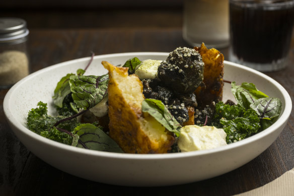 A medley of mushrooms with a potato “nest”, smashed peas and crisped kale.