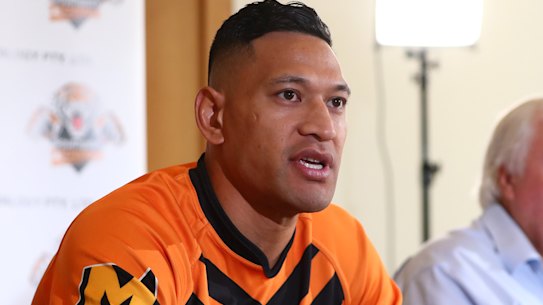 Israel Folau, pictured with backer Clive Palmer, said on Friday he was excited to return to the “grassroots level”.
