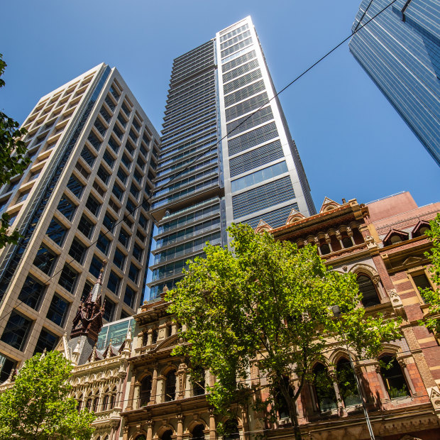 The Olderfleet tower behind 19th century gothic buildings on Collins Street.