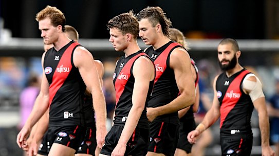 Essendon players take in their loss to Geelong on Sunday. 