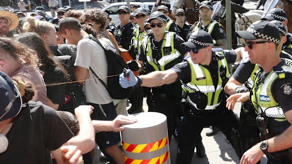 Police use pepper spray on protesters as they tried to top conference members entering IMARC.