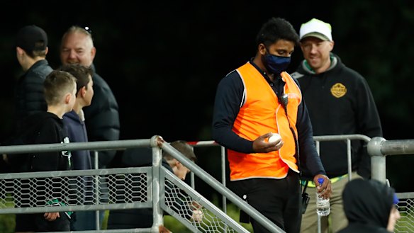 A security guard retrieves one of Ollie Davies' sixes at Manuka Oval
