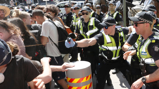 Police use pepper spray on protesters as they tried to top conference members entering IMARC.