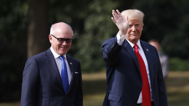 US President Donald Trump leaves Winfield House, residence of the US Ambassador Woody Johnson, left, during his visit to the UK in  July.