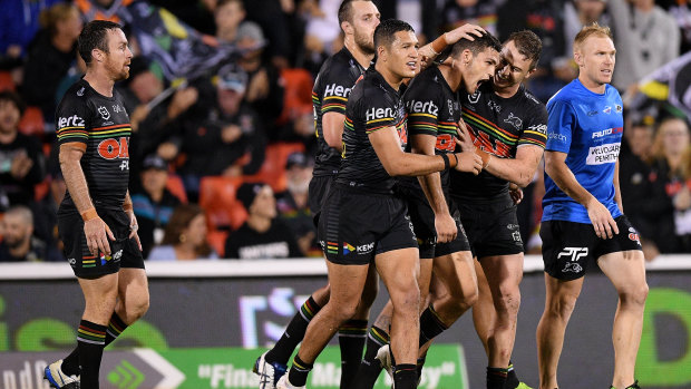 How the west was won: Nathan Cleary's teammates mob the halfback after his golden-point heroics.