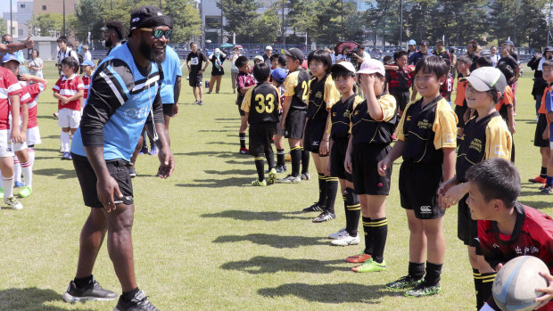 Back to school: Members of the Fijian team give a rugby clinic to elemental school students in Akita, northern Japan.