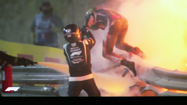 Sebastian Grosjean escapes his vehicle with the help of marshals.